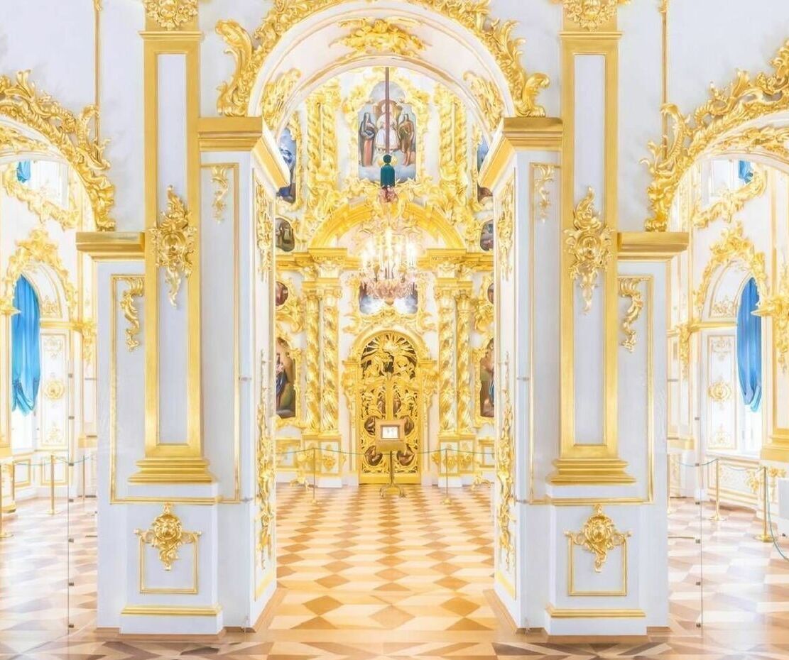 Lavishly decorated interior of Peterhof Palace featuring ornate gilded details and historic palace architecture