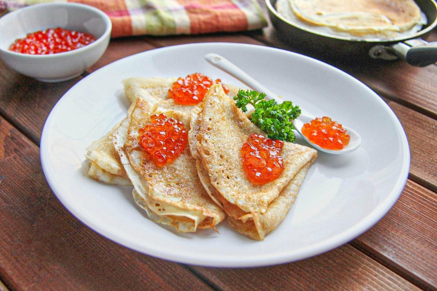 Russian blini pancakes served with red caviar