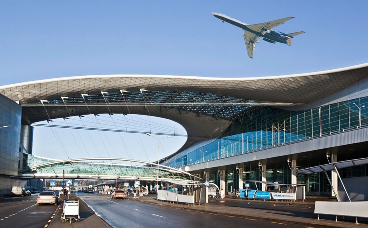 Airplane flying above Moscow airport terminal in Russia